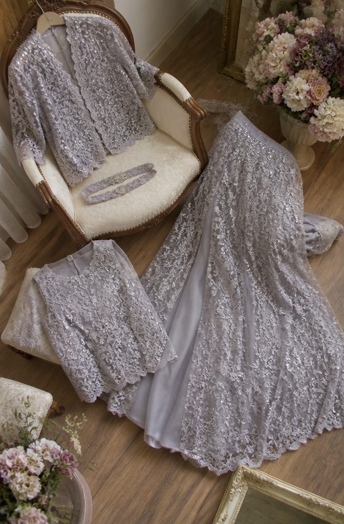 A grey lace ensemble with a skirt, top, jacket, and belt.