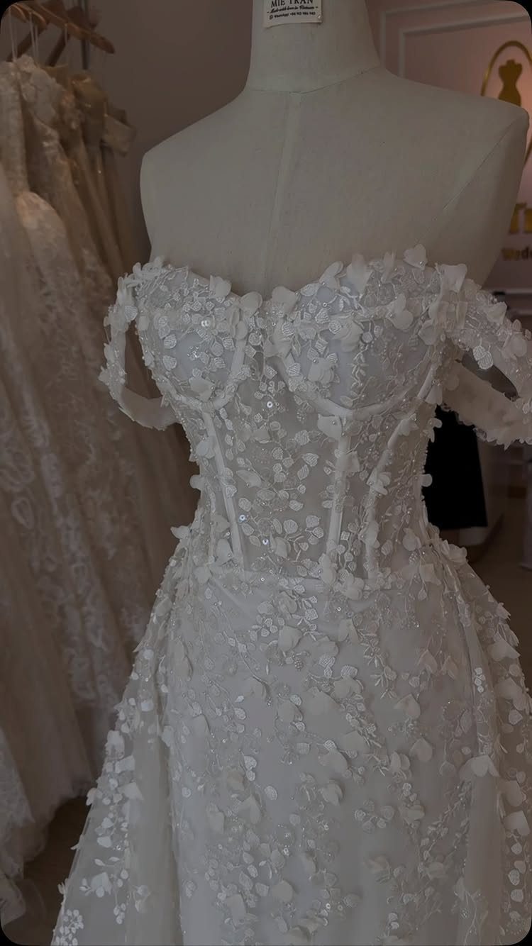 White wedding dress on a mannequin with a structured floral corset bodice