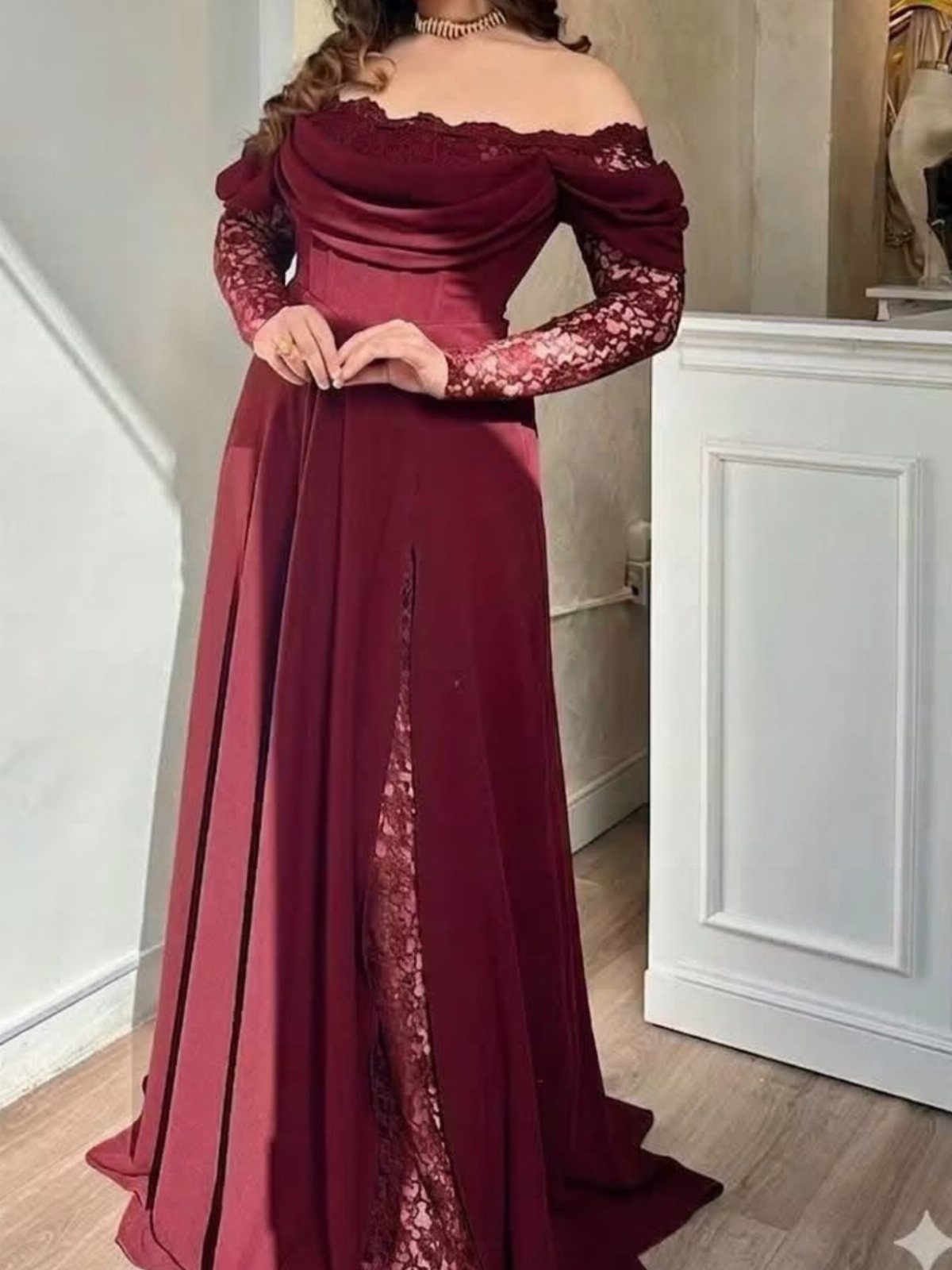 Woman in a burgundy off-the-shoulder lace dress with long sleeves and floor-length skirt.