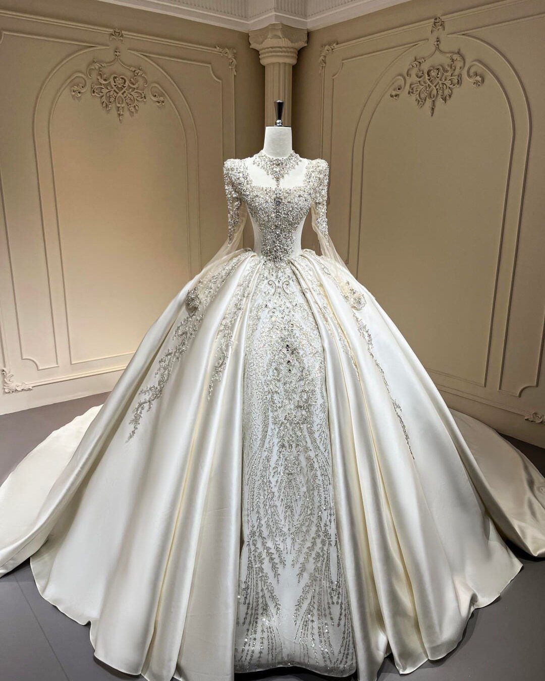 White ball gown wedding dress with silver beaded embroidery on a mannequin