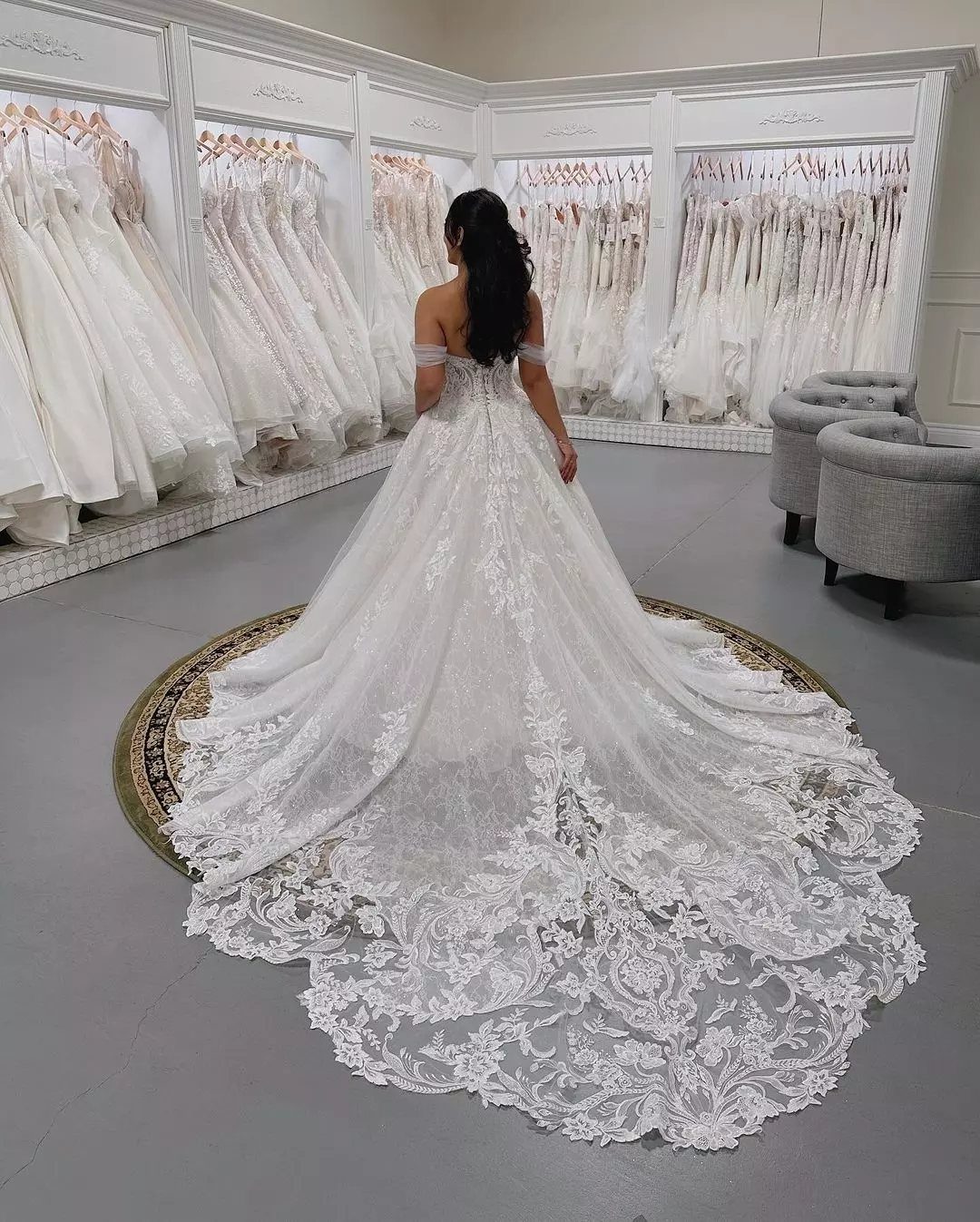 Woman wearing a white lace wedding ball gown with a voluminous long train