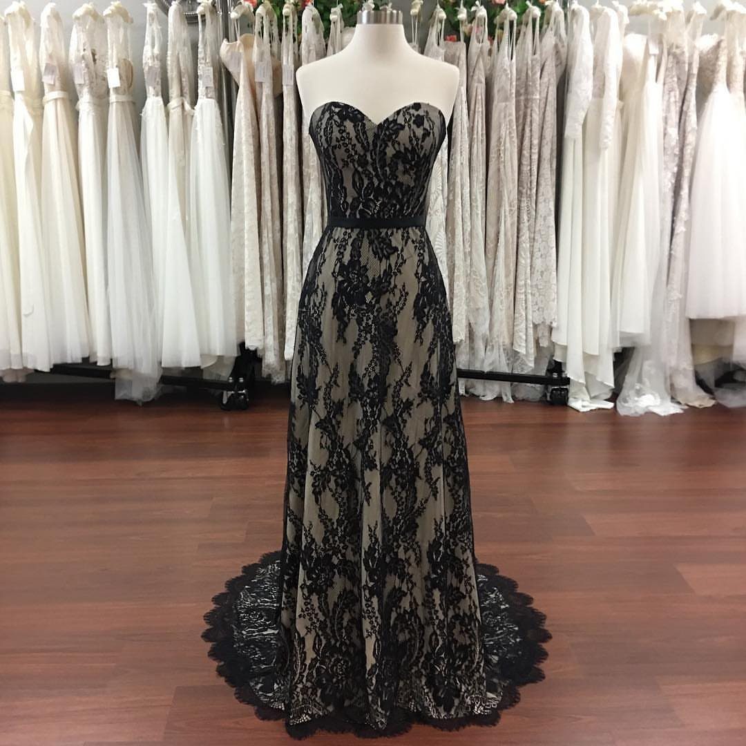 Strapless black lace wedding dress on a mannequin in a bridal shop