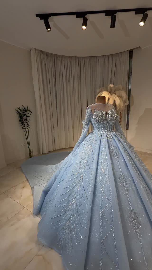 Light blue sparkling ballgown wedding dress on a mannequin in a bright room