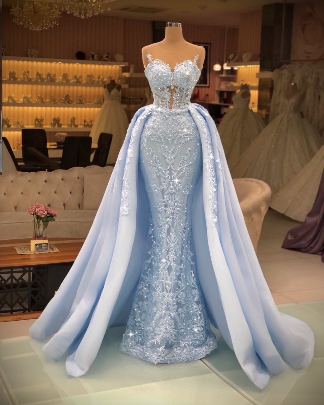 Light blue bridal gown with sequined detailing and a voluminous flowing overskirt