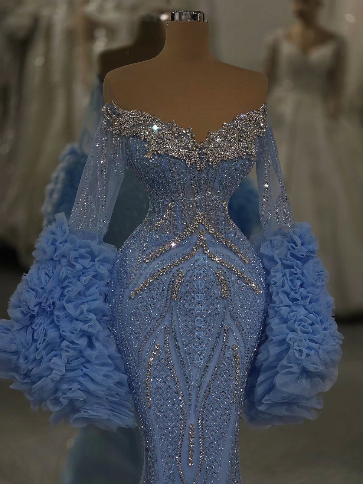 Light blue sequined bridal gown with ruffled tulle accents on a mannequin