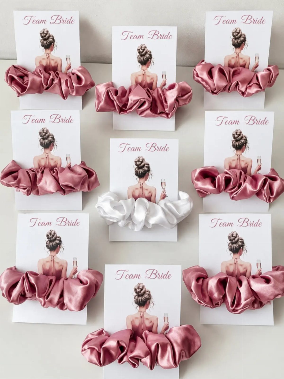 Mauve and white satin scrunchies on cards with Team Bride illustrations.