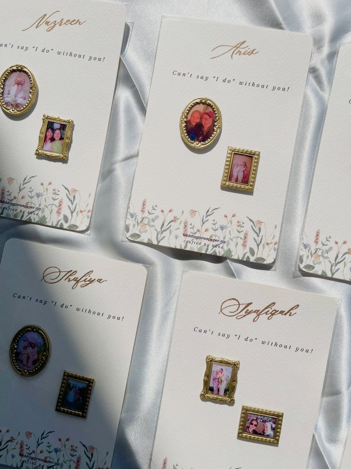 Gold-framed photo magnets on white proposal cards with floral accents and personalized text.