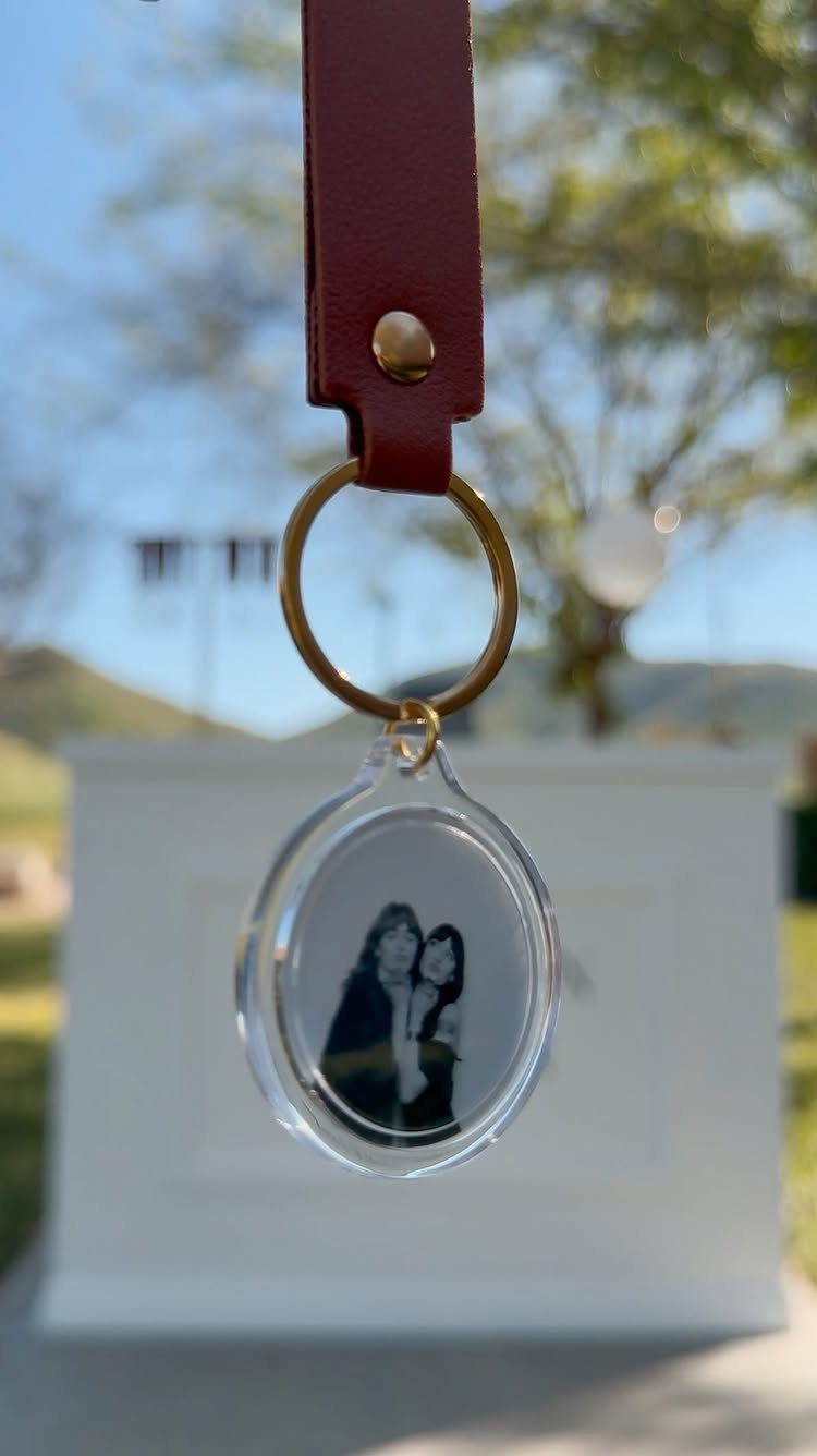 Personalized keychain with red leather strap and photo of two women in acrylic.