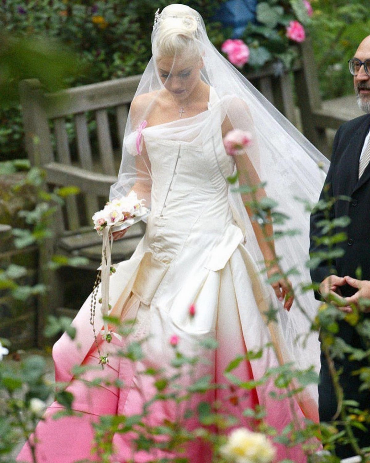 Gwen Stefani wearing a white wedding dress with a pink dip-dyed hem and veil.