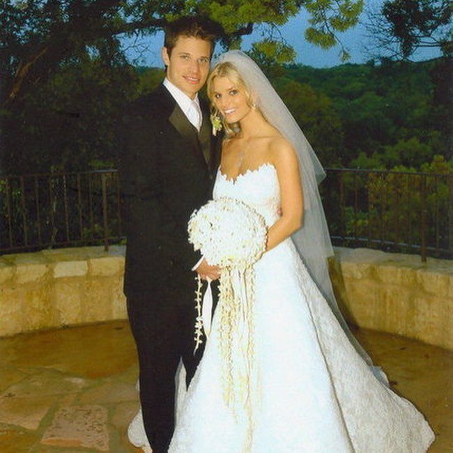 Bride in a strapless white wedding dress and groom in a black tuxedo.