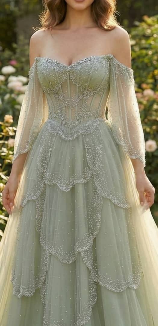 Woman wearing a pale green elvish wedding dress with shimmering tiered tulle skirt