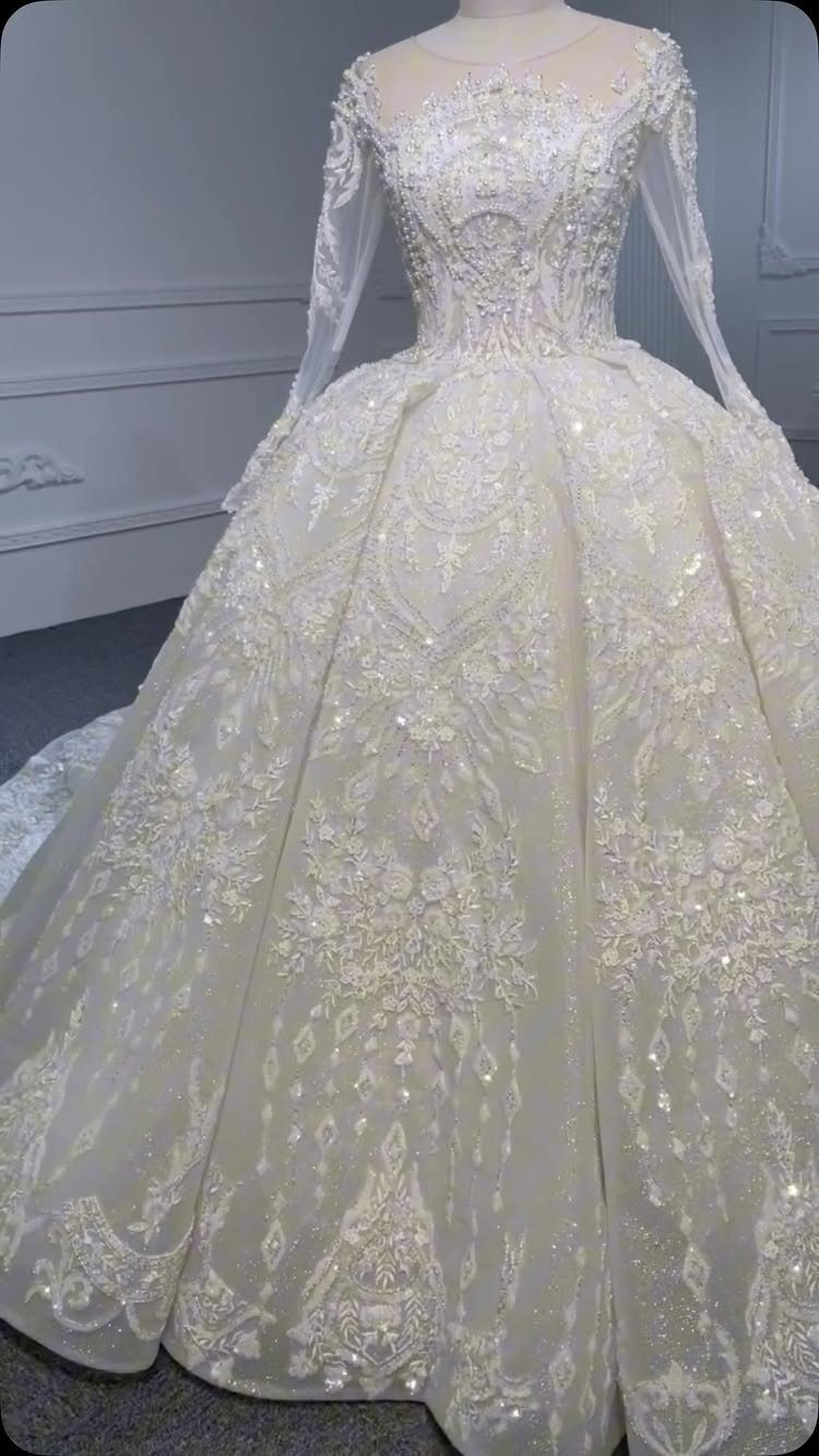 Ornate white ballgown wedding dress with silver embroidery on a mannequin