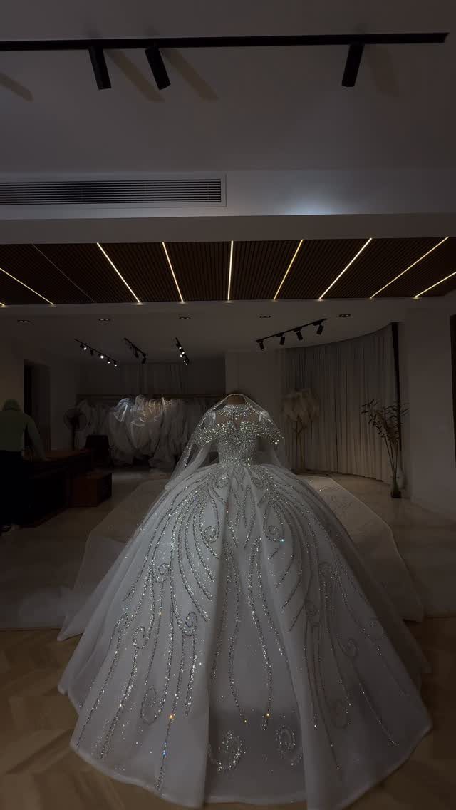 White ballgown wedding dress with silver beaded embroidery on a mannequin in boutique
