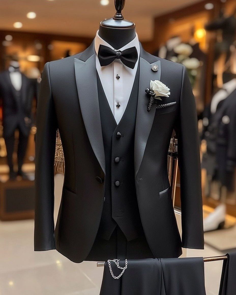 Black tuxedo with satin lapels, bow tie, and white rose on a mannequin