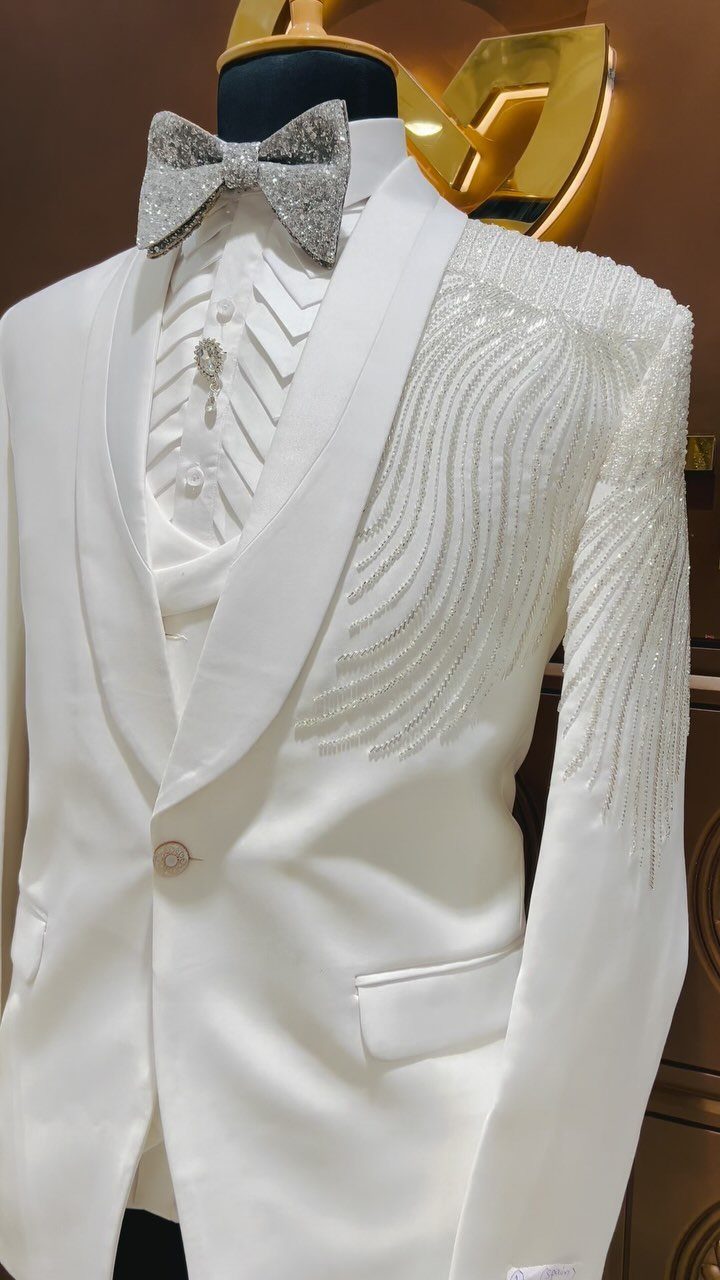 White tuxedo jacket with silver beaded detailing and a sparkling silver bow tie.