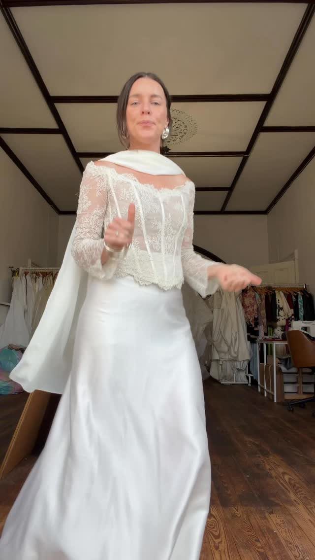 Woman wearing a white wedding dress with lace bodice and silk skirt