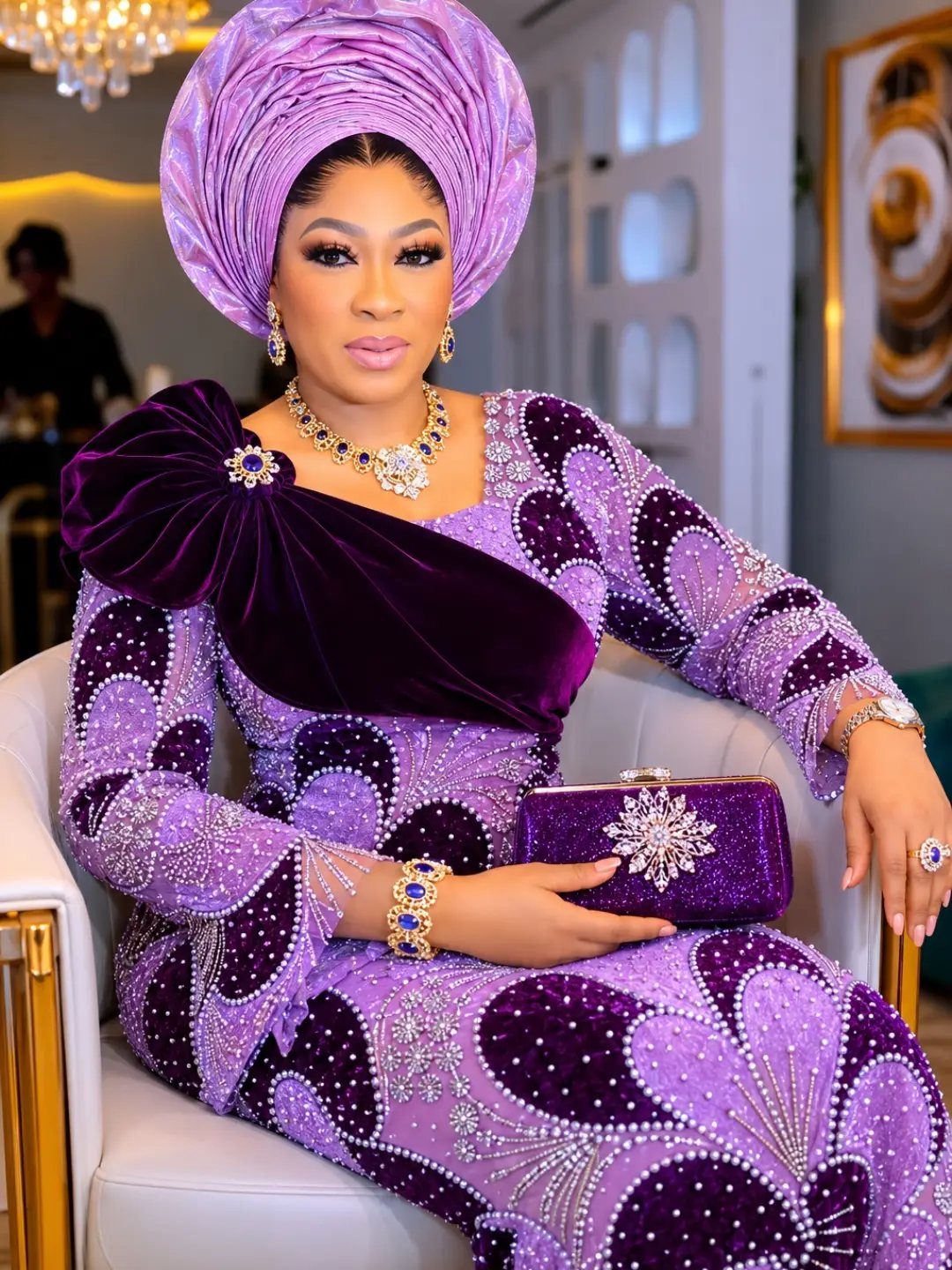 Woman in a purple beaded long dress and matching headwrap sitting in a chair.