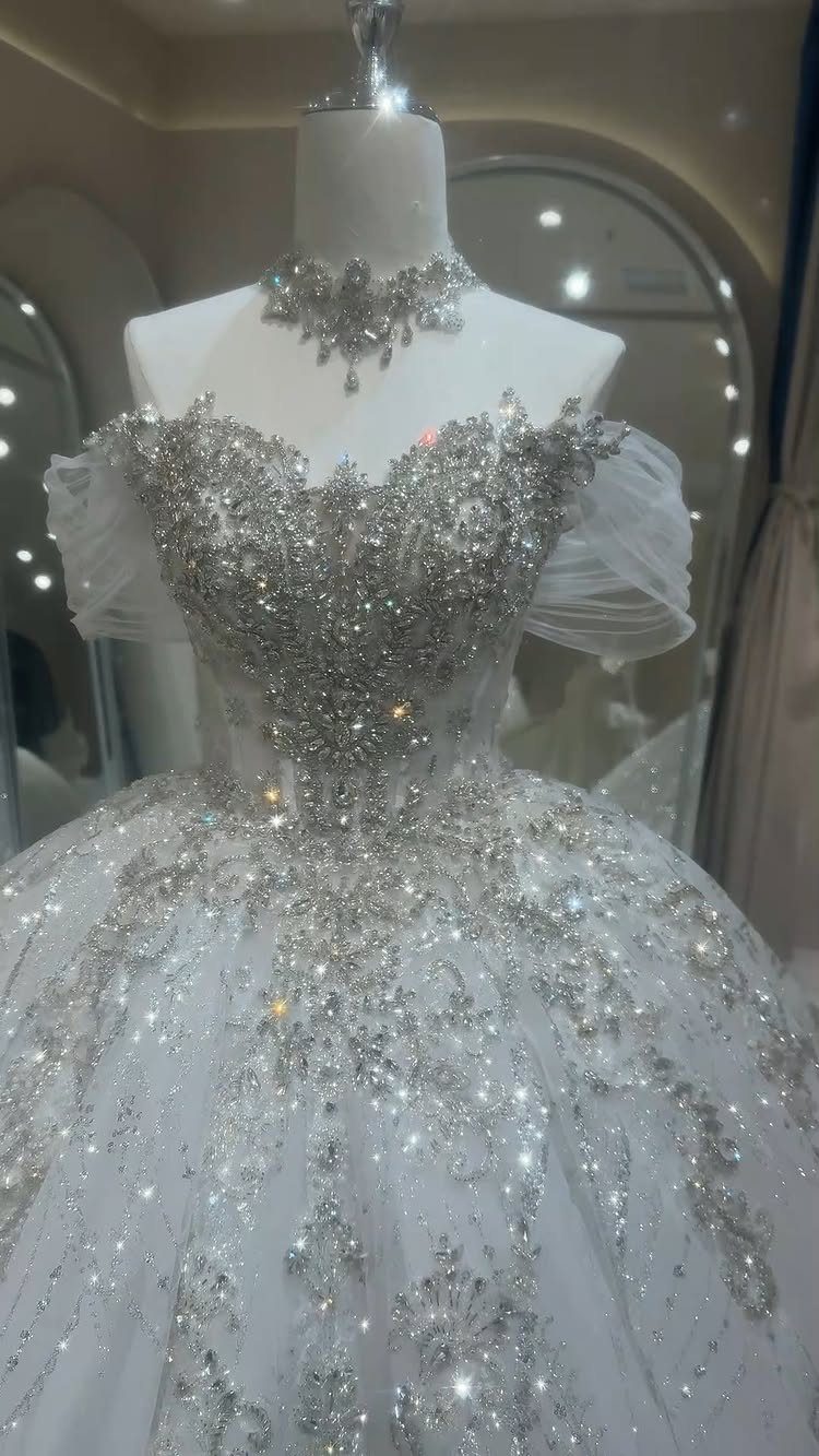 White ballgown wedding dress with heavy silver crystal embellishments on a mannequin