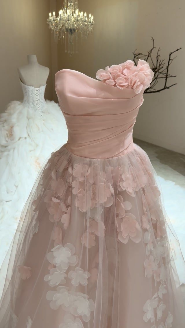 Pale pink strapless gown with 3D floral appliqués on a tulle skirt.