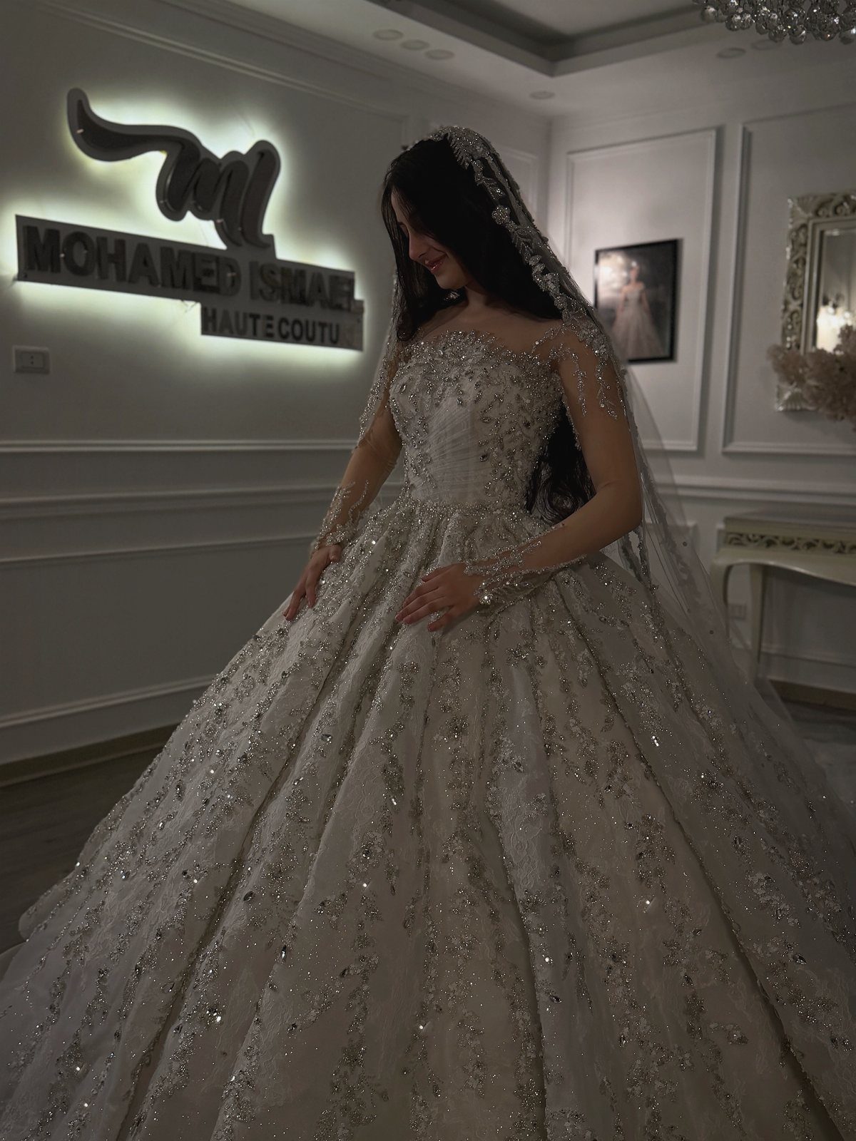 Woman in a sparkling white princess wedding gown with a voluminous skirt and veil.
