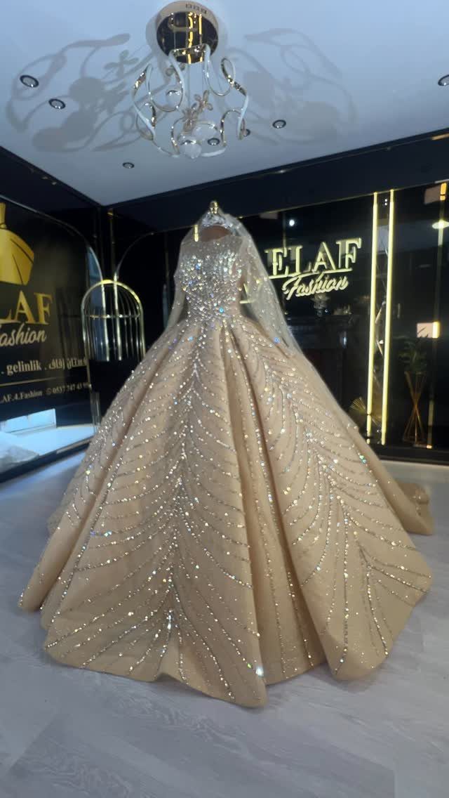Champagne tulle wedding dress with shimmering embellishments on a mannequin in a boutique