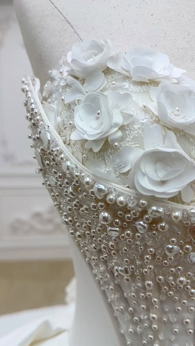 White couture wedding dress bodice with 3D fabric roses and pearl beadwork.