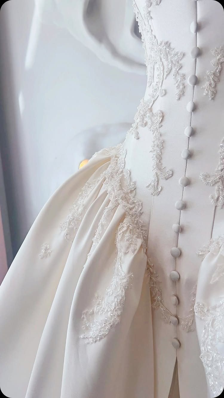 White couture wedding dress back with lace embroidery and fabric covered buttons