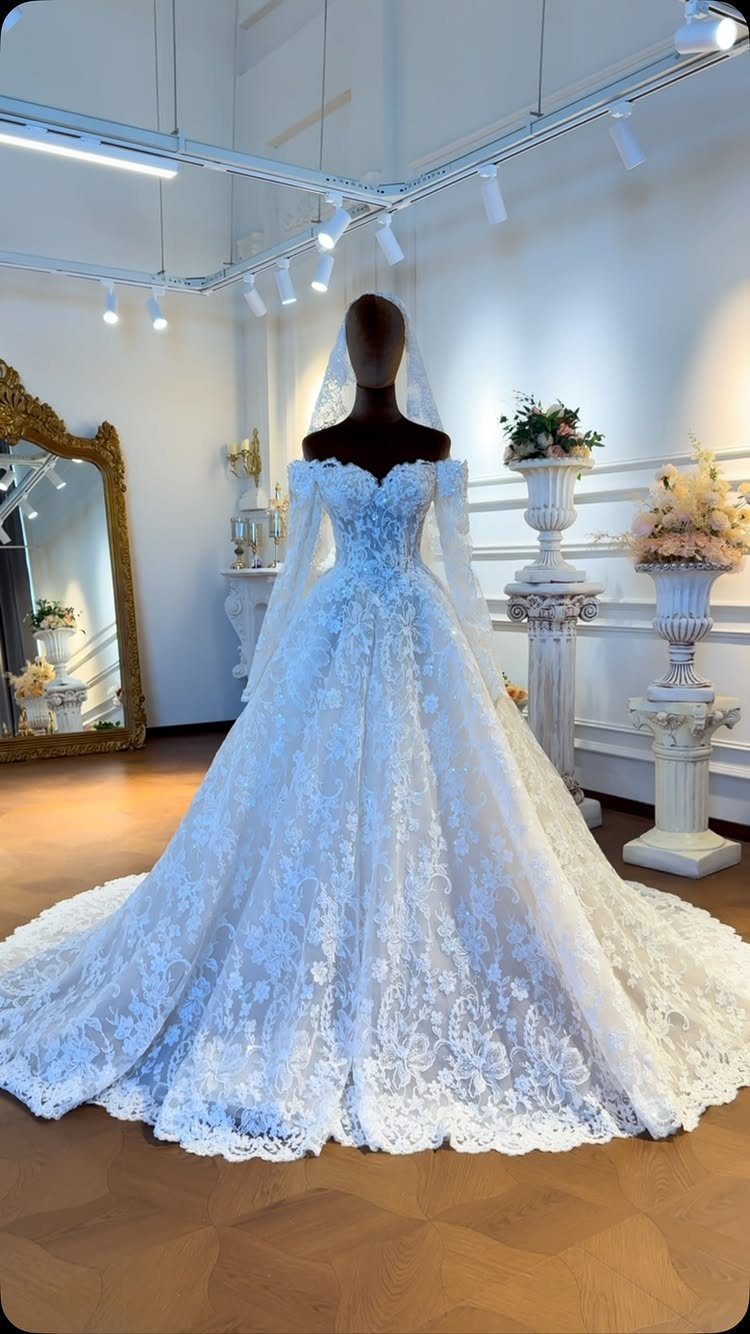 White lace couture wedding dress with full skirt on a studio mannequin