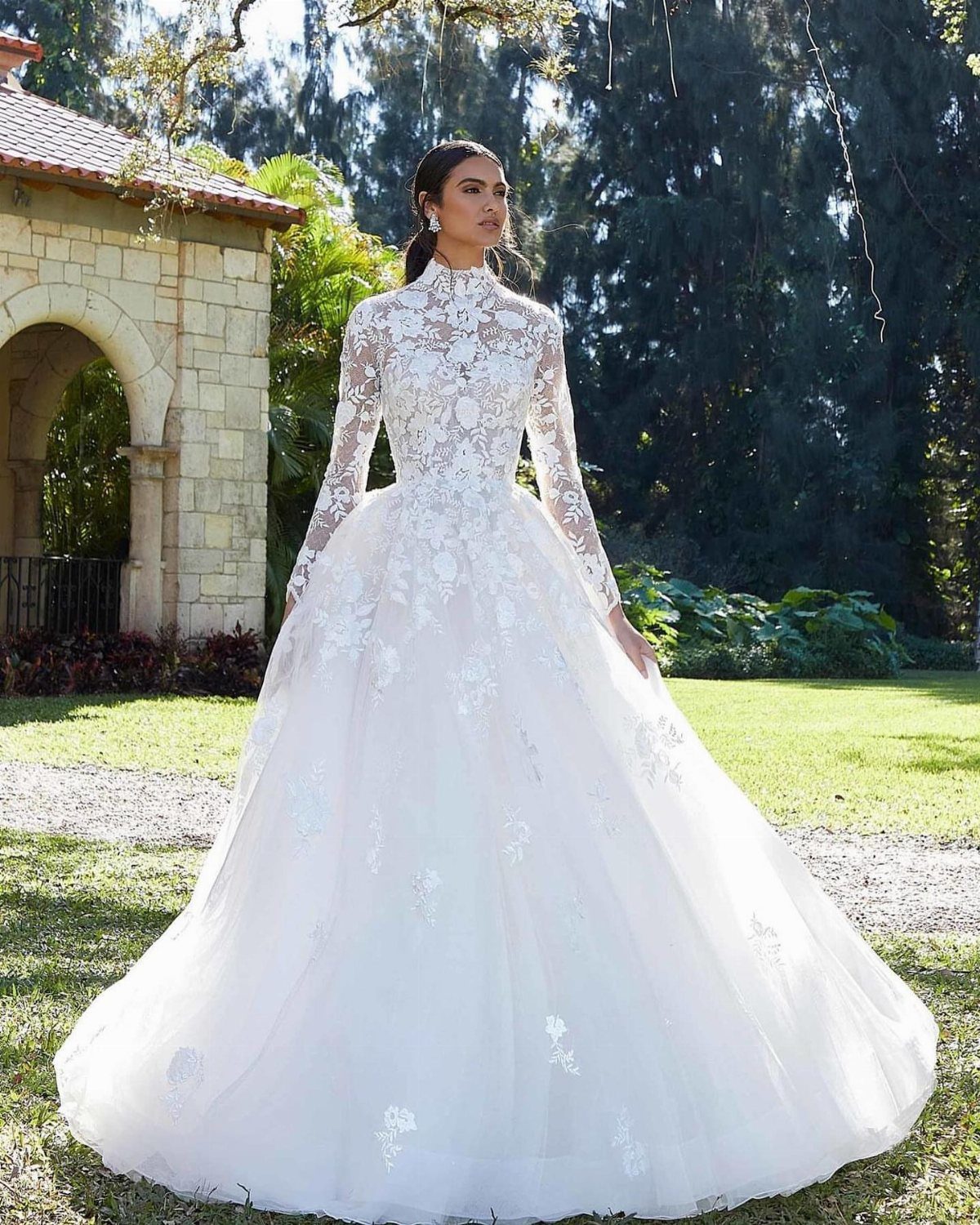 Woman in a modest white wedding dress with high neck and long sleeves.