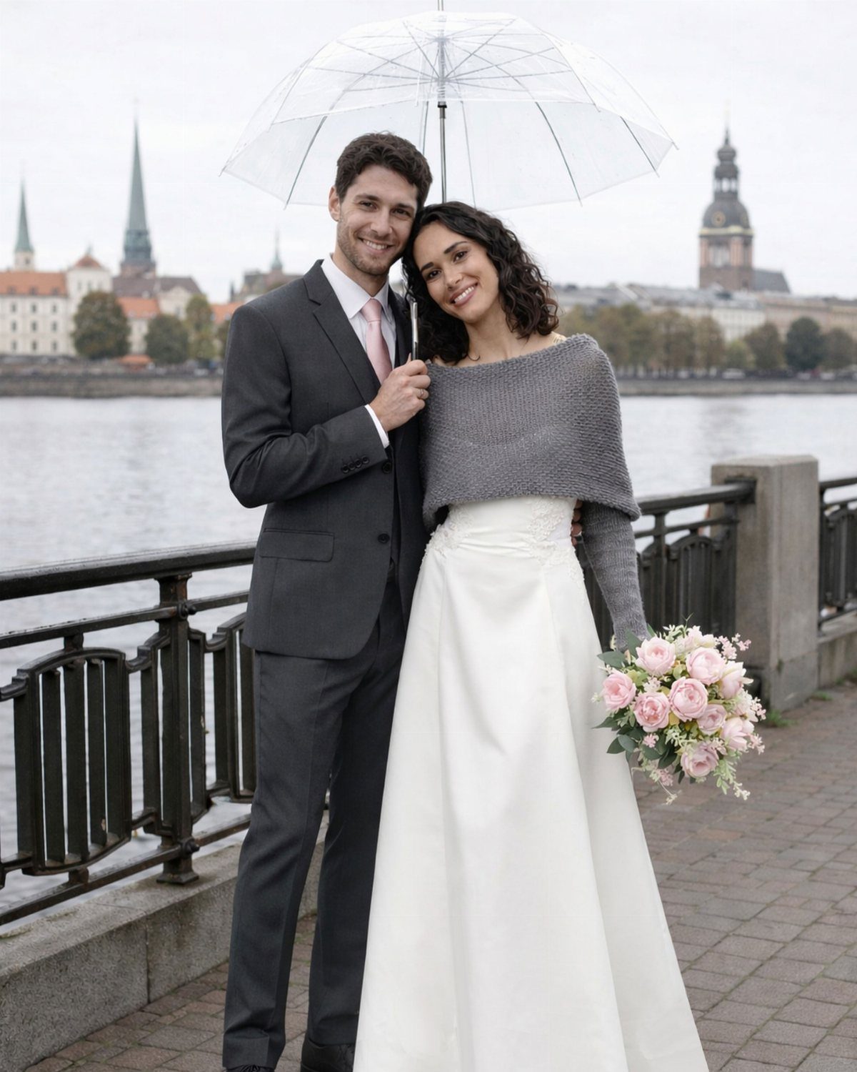 Bride wearing a grey knitted shawl over her white wedding dress with groom.
