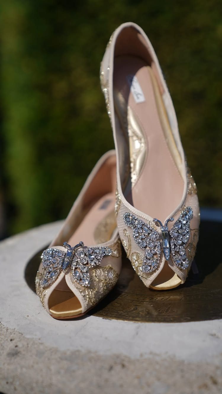 Champagne bridal ballet flats with sparkling crystal butterfly embellishments on the toes.