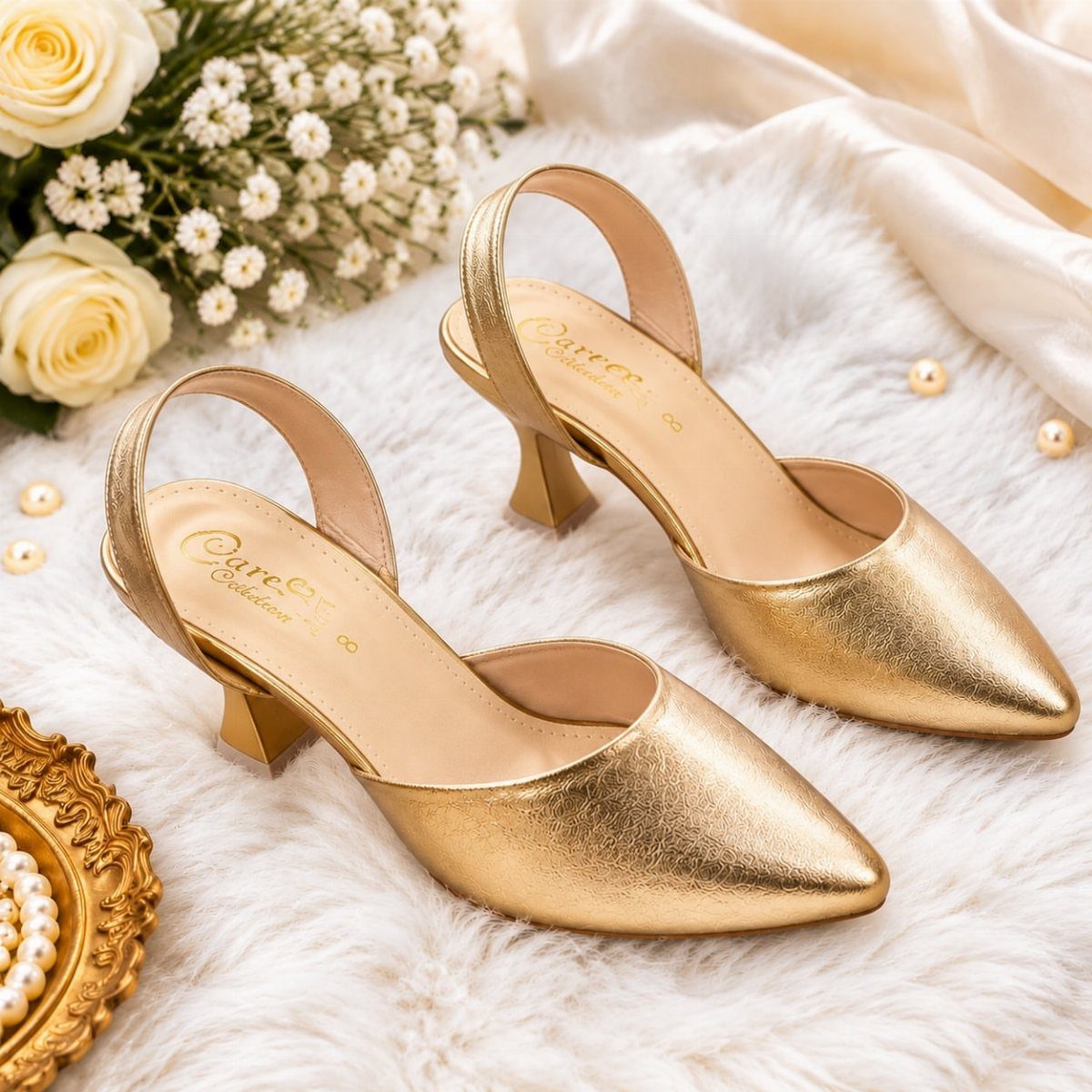 Gold metallic slingback wedding heels on white fur with roses and pearls.