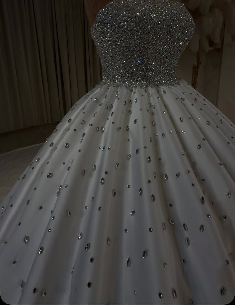 White ball gown wedding dress with beaded bodice and crystal-embellished full skirt.