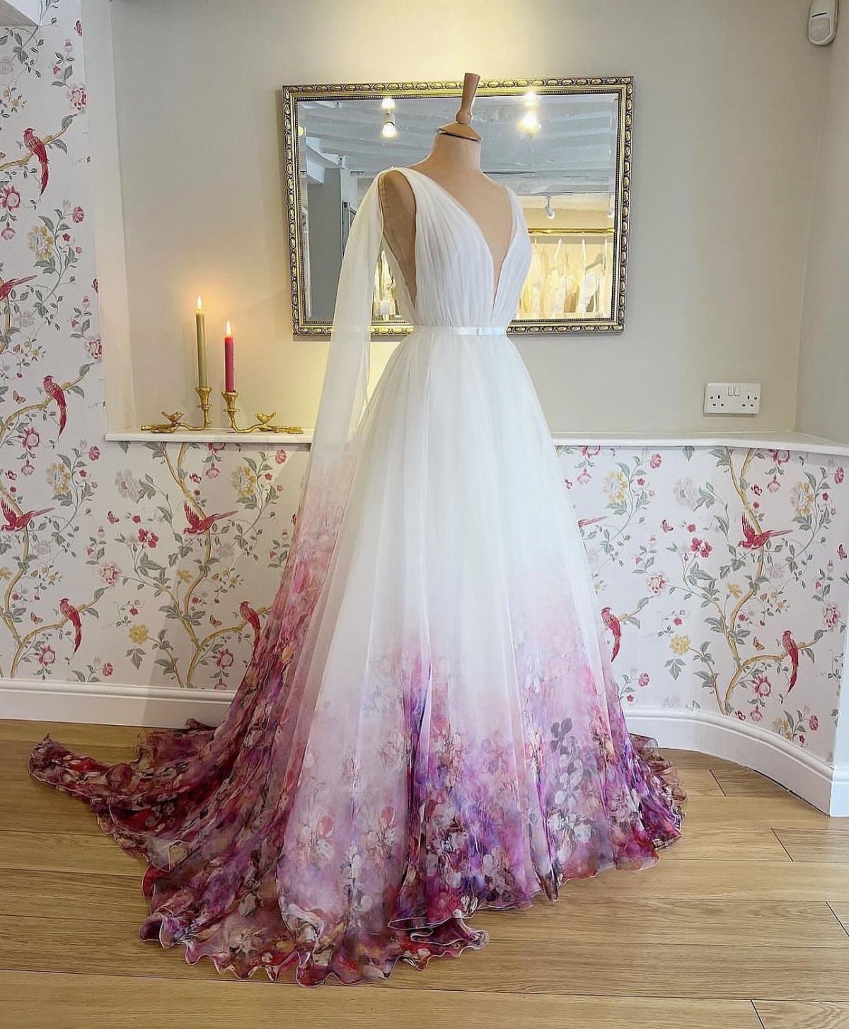White wedding dress on a mannequin with purple floral print on the train