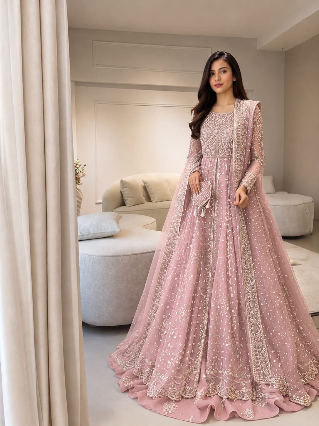 Woman in a sparkling pink embroidered wedding gown standing in a modern room