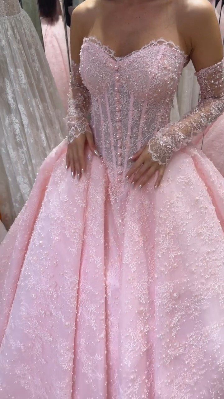 Light pink beaded wedding dress with a corset bodice and full glittery skirt