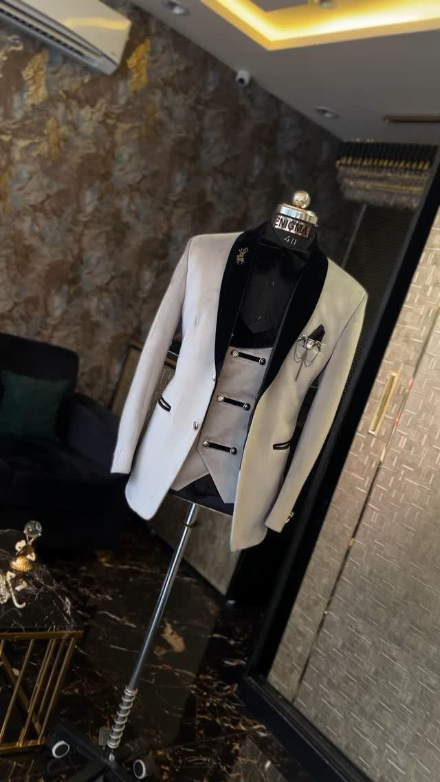 White tuxedo jacket with black lapels and waistcoat on a mannequin.