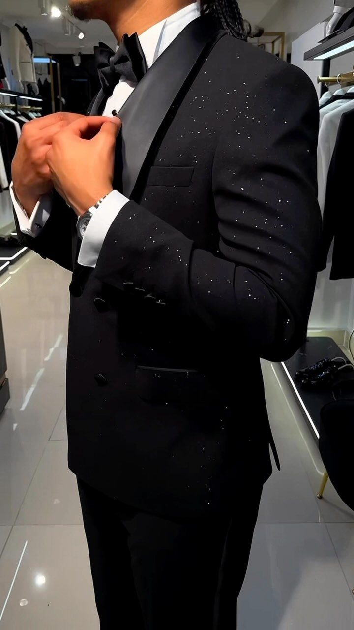 Man wearing a black tuxedo with a bow tie in a clothing store