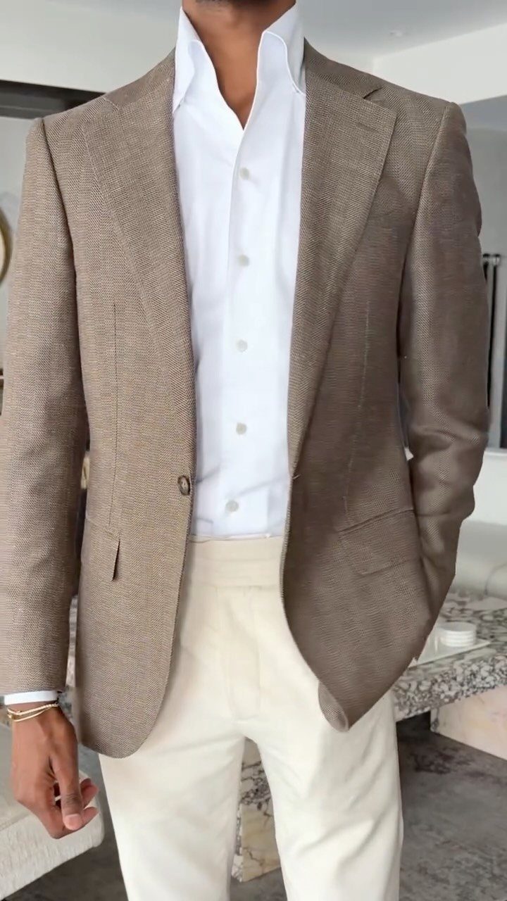 Man wearing a brown textured blazer, white shirt, and cream trousers for a wedding.