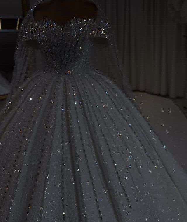 Sparkling white ballgown wedding dress with glittery bodice and full shimmering skirt